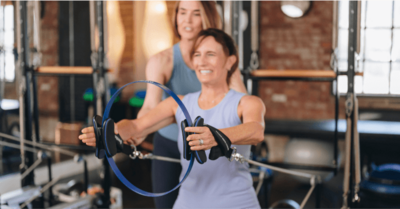 woman holding a workout ring in a pilates studio 