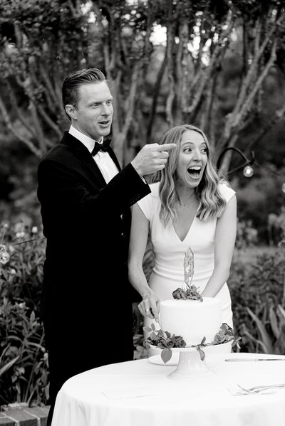 Bride and groom cutting cake and laughing at this Clifton Inn Charlottesville wedding