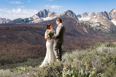 Bride and Groom exchanging vows face to face on a ridge in Sawtooth Mountains