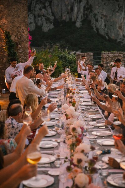 guests toast to wedding couple at sunset on Amalfi Coast