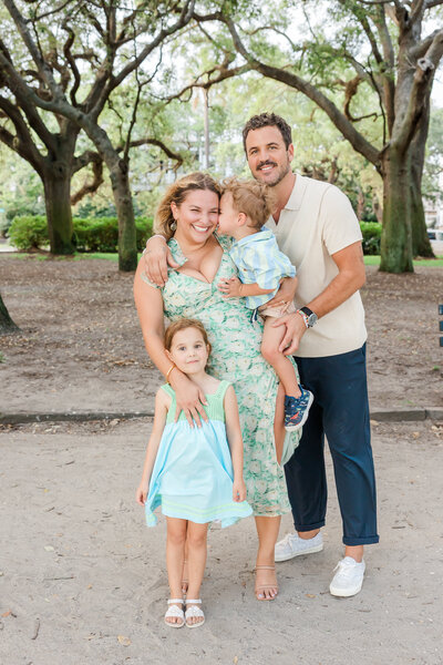 A family of four wearing casual clothing at a park in Summerville SC