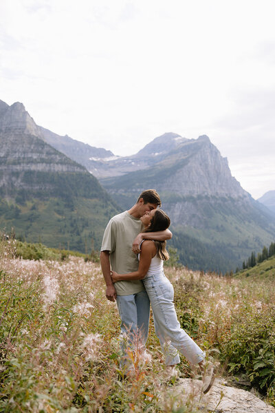 couple embracing in a kiss in glacier national park