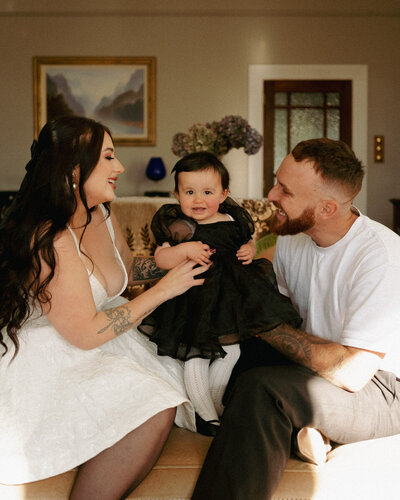 A gorgeous generation portrait of a family sitting on the steps at Cornwall Park in Auckland. Captured by Eilish Burt Photography