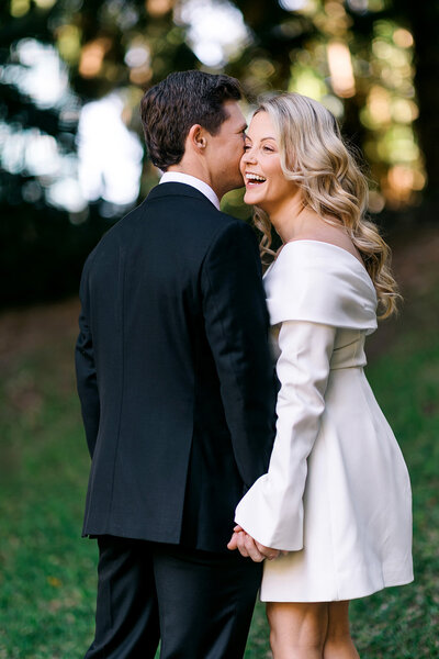 Couple share a candid moment laughing together after Brisbane Registry Office wedding