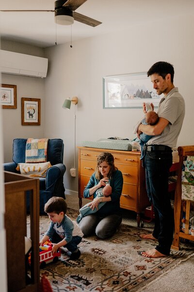 Baby looks at parents in photo taken by Loveland Newborn Photographer