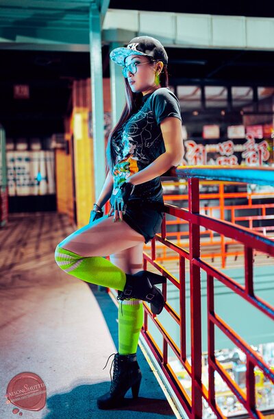 Kimmy Tran posed against fence in Chinatown wearing  Space Jam outfit and lime green socks