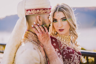 Indian and white fusion bride holding her groom's face before the hindu wedding at grandview poughkeepsie