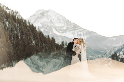Utah Wedding Photographer captures bride and groom kissing during mountain wedding