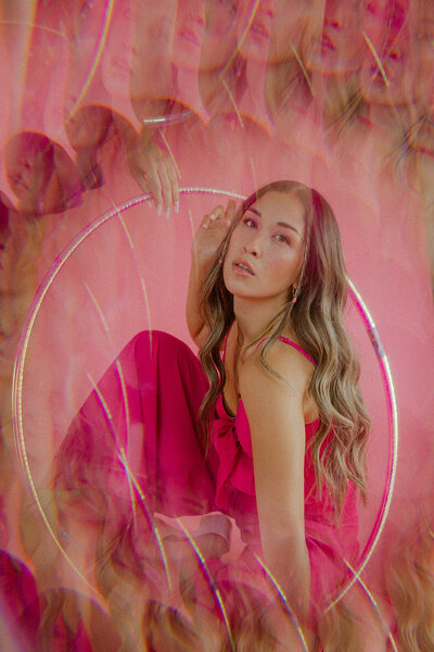 Woman posing with pink background at The Gathering Place in Las Vegas