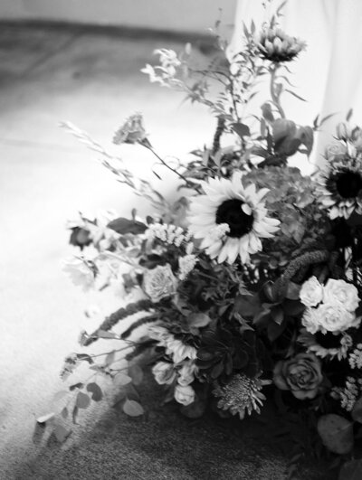 A black and white film photograph of a floral installation at a wedding reception at Upper Larimer in Downtown Denver.
