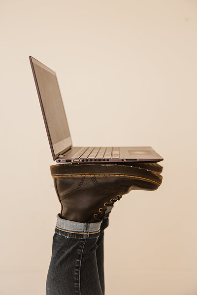 Brand + Website Design for service-based businesses|Virtual Vision|1 Page Website + Mini Branding| Mad Impact Design|Doc Marten boots balancing a HP laptop