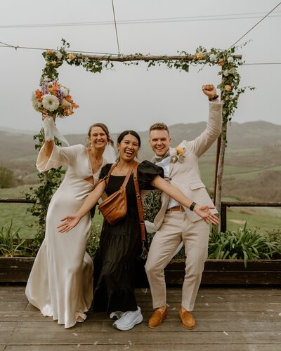 photographer posing with couple