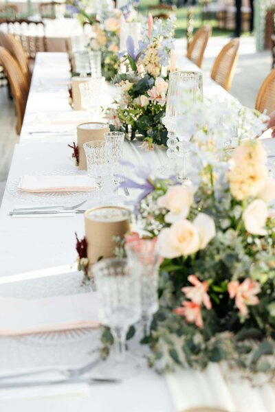 wedding tablescape with flowers, cutlery and crystal glasses