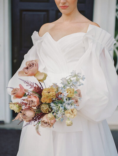 textural and organic floral centerpiece on a green linen table in the woods at a private estate wedding in ohio