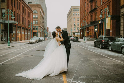 Couple in Downtown Milwaukee looking at each other on their wedding day.
