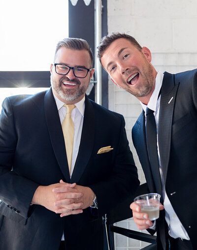Men smiling at a corporate event