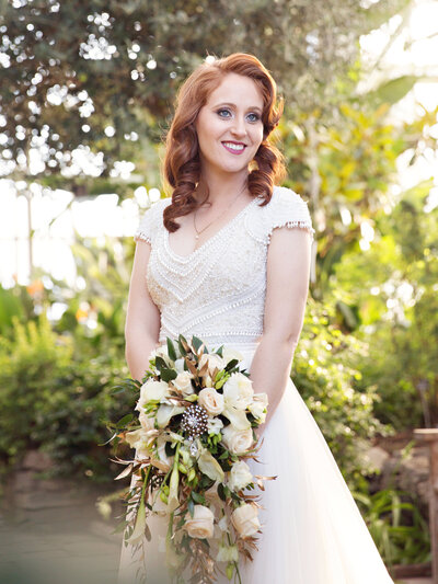 bride with bouquet red hair golden light at Royal Botanical Gardens in Burlington