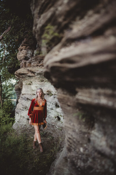 Soft portrait of Caroline near a cliff, embodying trust, inner strength, and connection to earth energy.