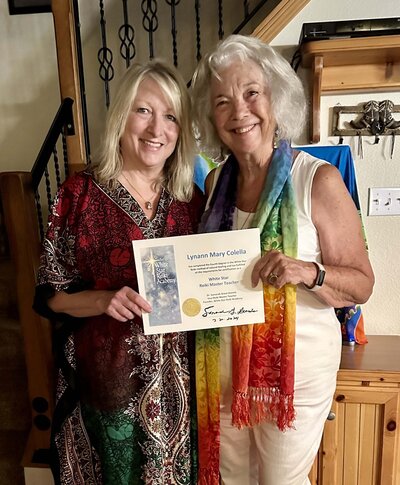 White start reiki instructor Samarah Grace with student getting certificate