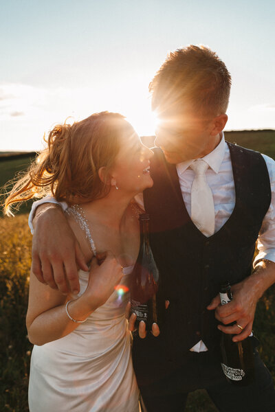 Devon Wedding Photographer takes shots of couple at sunset