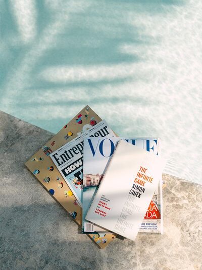 Stack of magazines on the edge of a pool