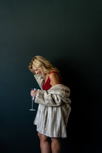 Candid shot of laughter and movement during an empowering boudoir session.
