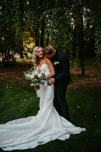 Newlyweds pose for a beautiful photo among the fall trees at The Tapestry House Venue by Wedgewood weddings in Laporte, Colorado