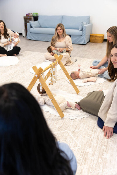 Group of moms playing with their babies on the floor