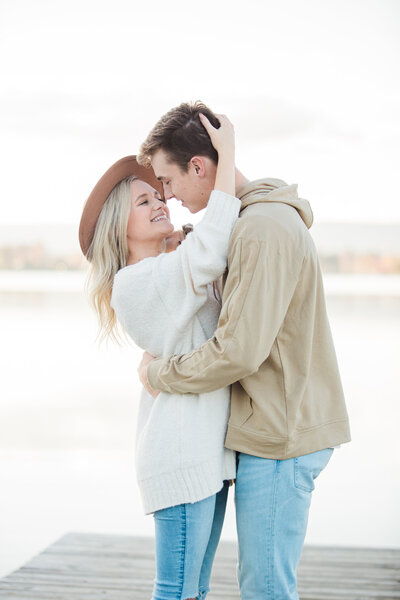 engaged couple holding each other on a dock in Chattanooga