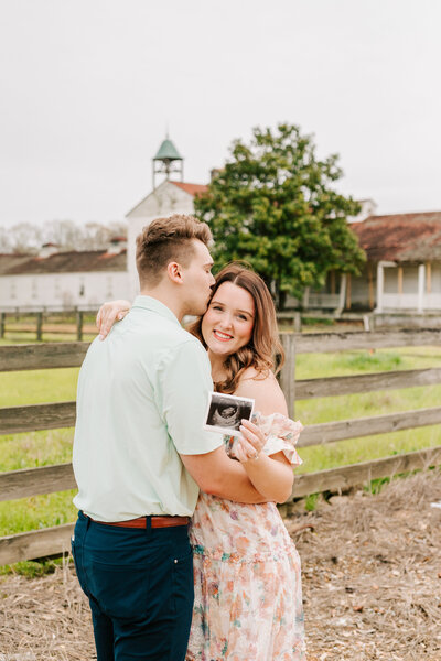 A daughter and son hug on their family lab during their family session.