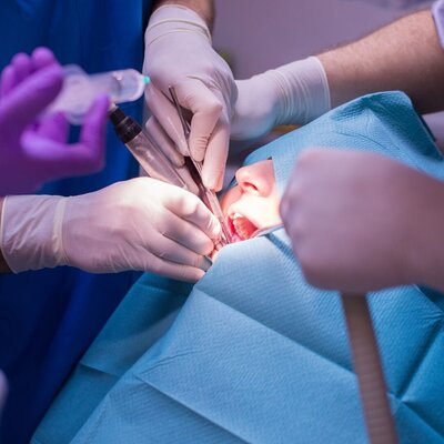 Prosthodontist performing oral surgery procedure for full mouth restoration that was a prosthodontics referral in Lethbridge, Alberta.