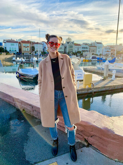 Madison standing outside in front of boats