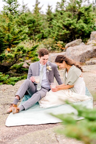 Couple during a coffee picnic after their vows. Captured by their New England Elopement Photographer