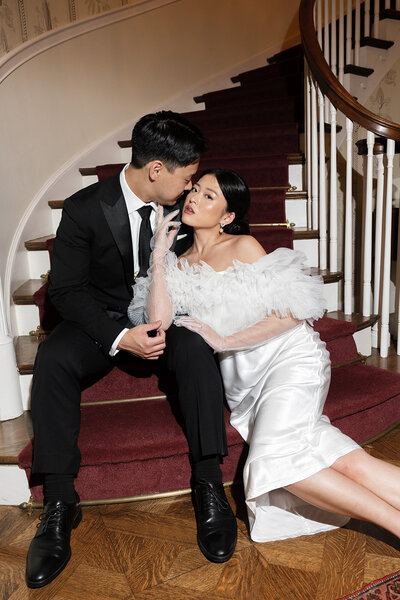 Married couple sitting on stairs posing for candid shot