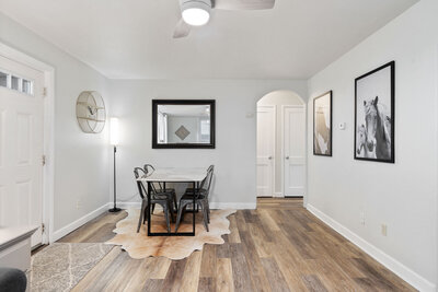 dining area with table and cowhide rug