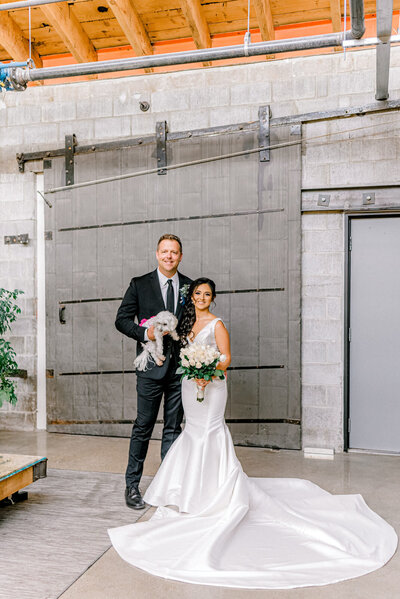 bride and groom with their dog at the Living Room Omaha