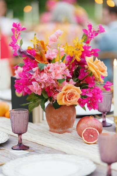 A colorful floral arrangement on a wedding reception table 