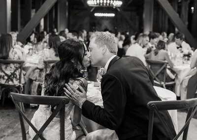 Wedding Photography, Sonoma Wedding at Ramekins Culinary Institute, black and white of groom lifting bride up for a kiss