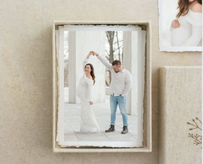 matted prints in a pile with a maternity photo on the top by york pa photographer 