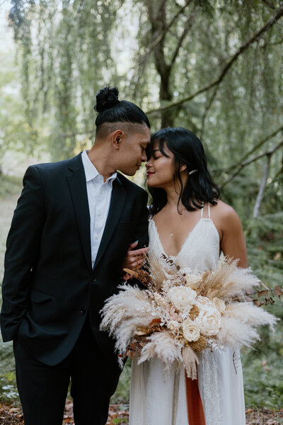 Romantic first look surrounded by moss-covered trees in the Pacific Northwest
