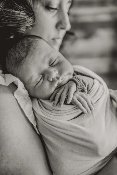 mom holds newborn baby at her home in dallas texas