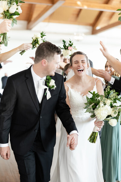 couple laughing with each other on wedding day taken by minneapolis wedding photographer
