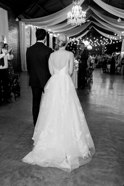 bride and groom enter indoor wedding reception in GA