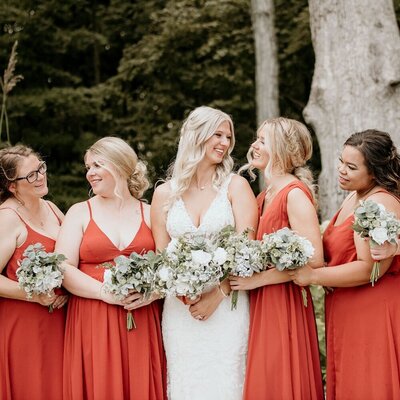bride with bridesmaids in salmon dresses