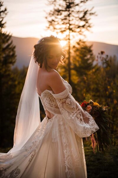 A bride hold her bouquet in the golden evening light on on a summer day in Montana.