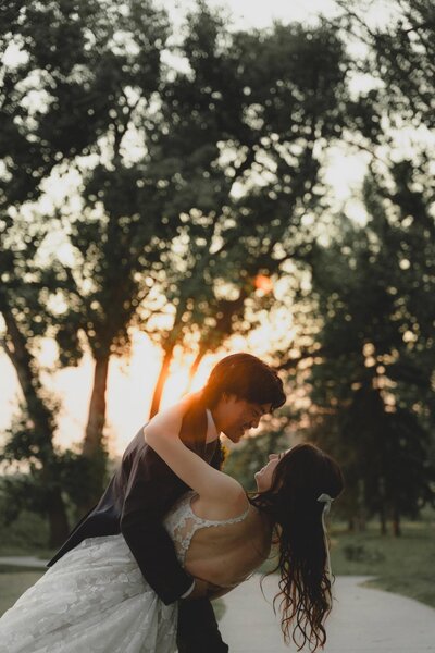 Wedding Couple dipping in front of a sunset