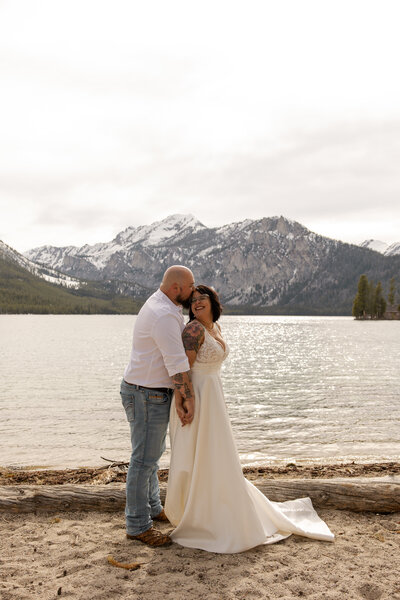 groom holding bride in front of a watefall by montana elopement photographer