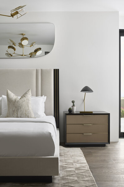 JSF Design bedroom with custom light fixture and styled mirror accent