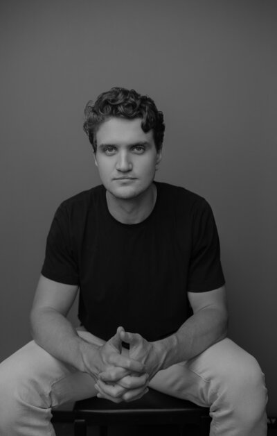 Man sitting for headshot in a chair