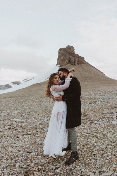 engaged couple hugging in mountains of Alberta